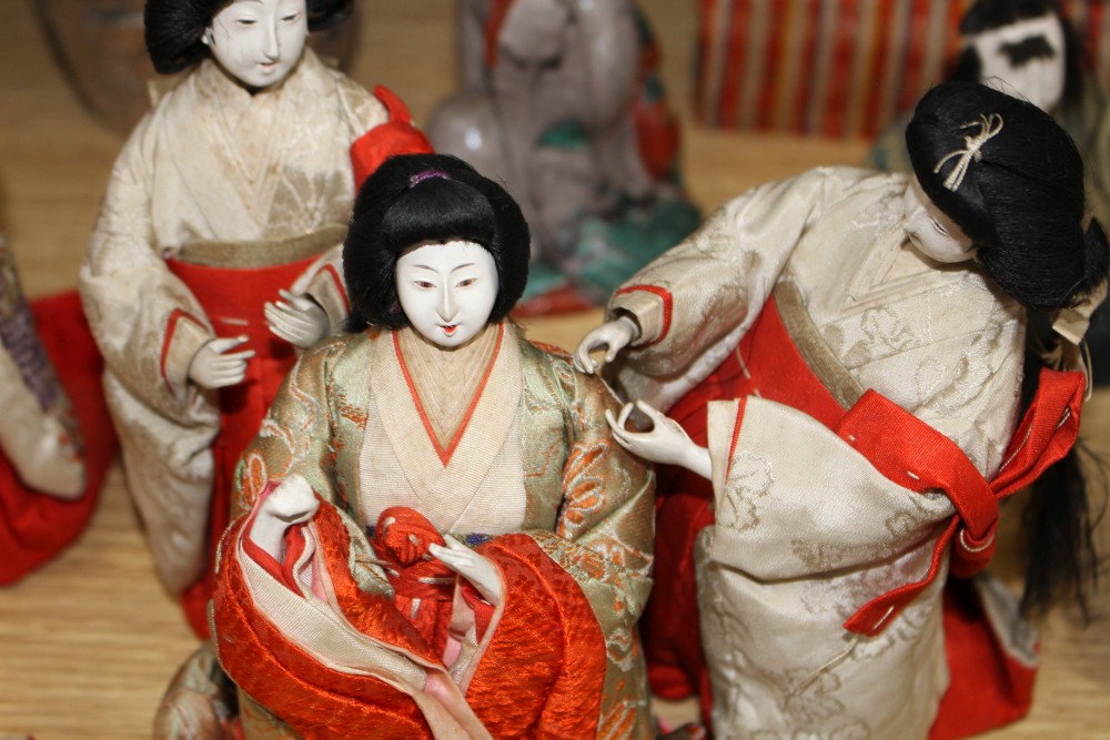 A set of five Japanese late Meiji period Hinamatsuri lacquered wood and fabric female dolls and five similar male dolls, all kneeling w